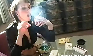 Older doxy holding a cigarette and playing with herself